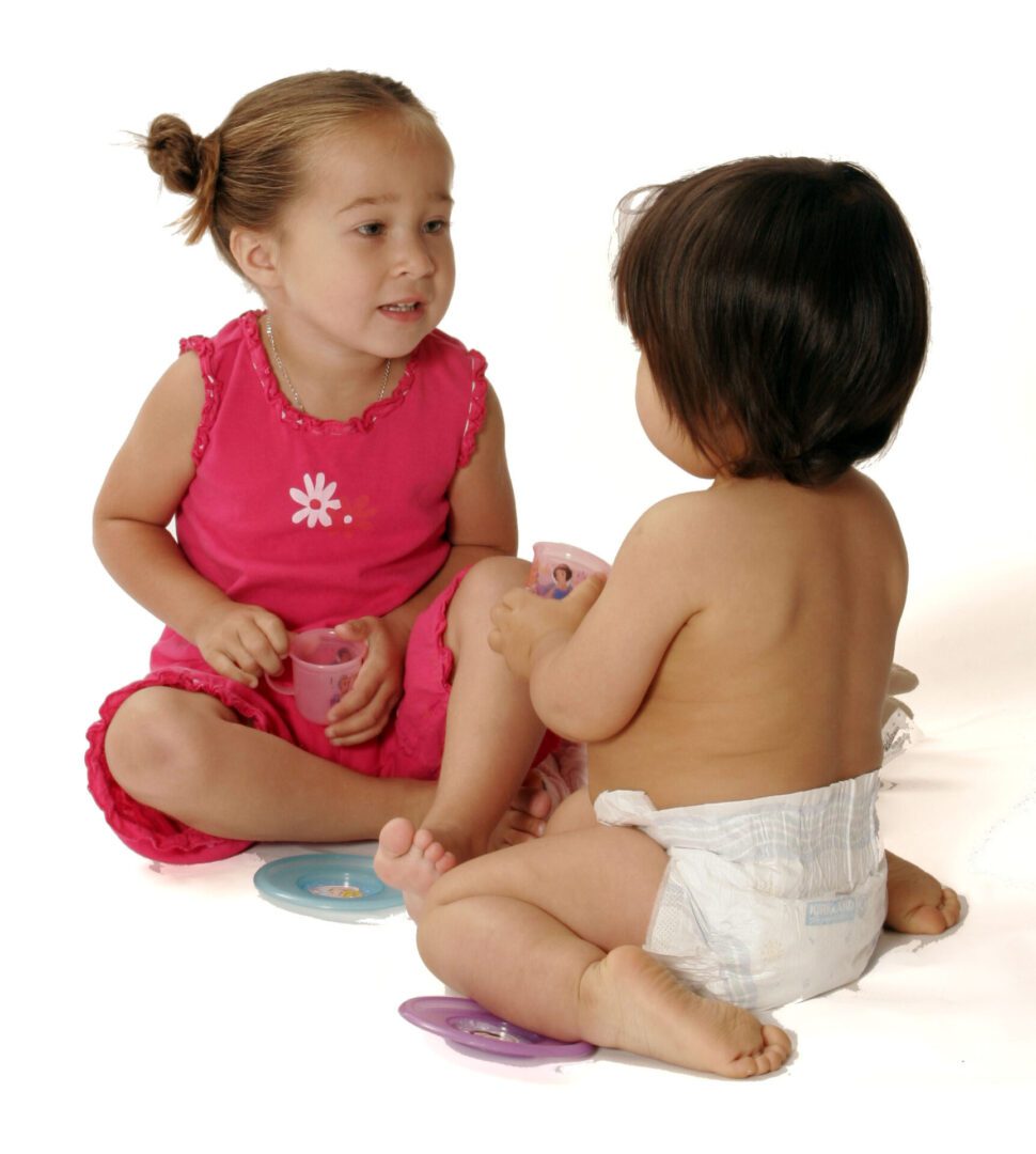 A girl in a pink dress demonstrating social emotional development.