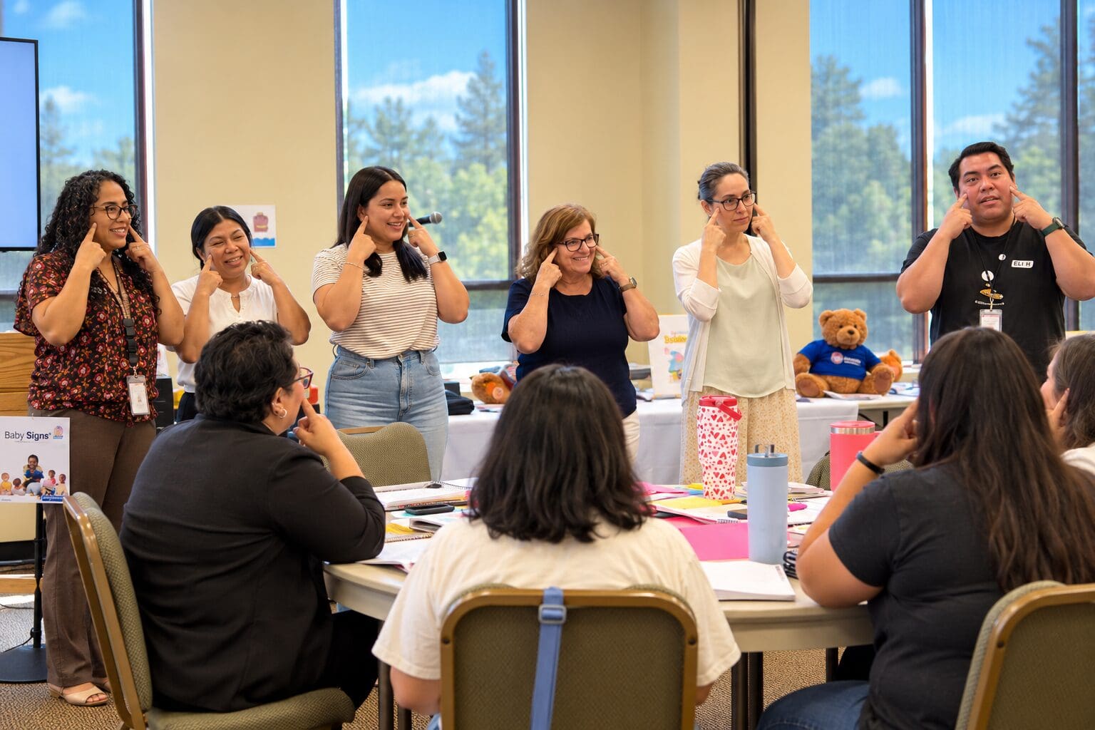 Participants practicing signs together during an in-person Baby Signs® Instructor Training workshop in Oregon.