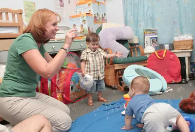 A group of people teaching children in a room.