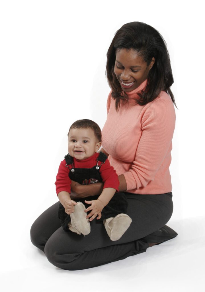 Woman holding a baby on her lap.