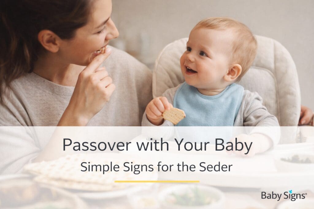 Parent showing baby the sign for eat while holding matzo at a Passover table