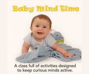 Smiling baby on tummy with blanket promoting Baby Mind Time class