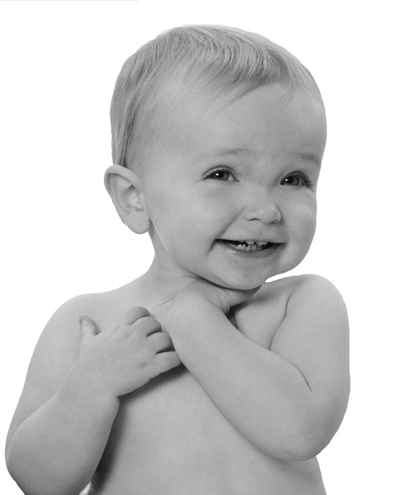 Baby expressing emotion through facial expression and hand gestures before spoken language develops