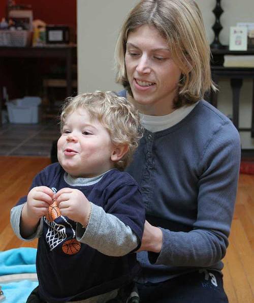 Early intervention professional engaging with a toddler using the Baby Signs® Program to support communication.