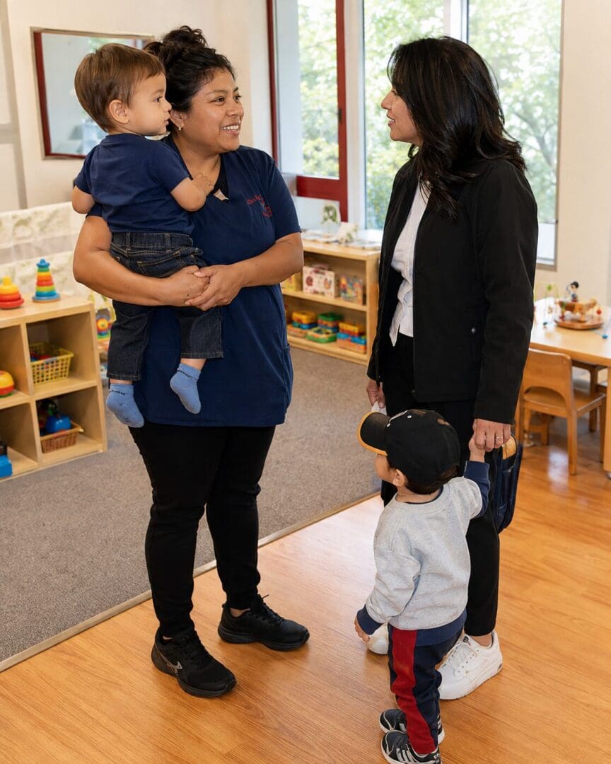 Parent and child care provider talking together during a toddler’s child care drop-off