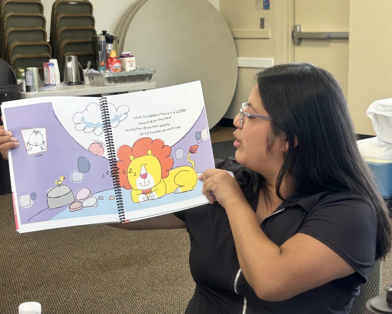 A Baby Signs® training participant holding a Circle Time book featuring a lion during an in-person Instructor Training.